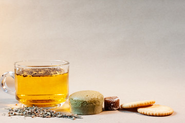 Cheese cakes,tea cup, sugarcane, dried tea leaves and crackers  on paper. Sweetmeat concept. Macha flavor.