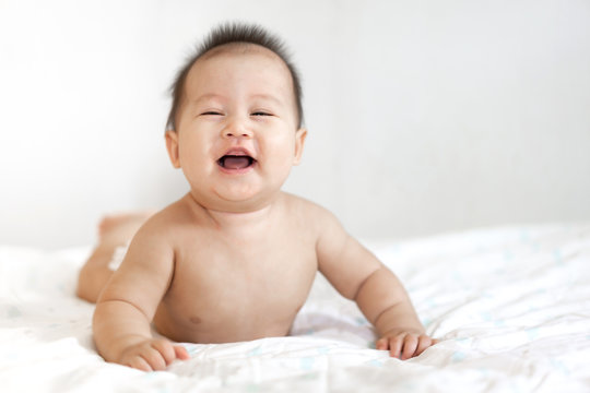 Portrait of happy smile baby relaxing on the bed