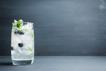 Blueberry mojito cocktail on the wooden background. Selective focus. Shallow depth of field.