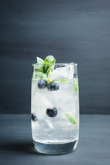 Blueberry mojito cocktail on the wooden background. Selective focus. Shallow depth of field.