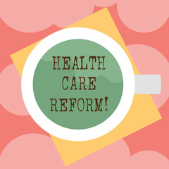 Writing note showing Health Care Reform. Business photo showcasing general rubric used for discussing major Medical policy Top View of Drinking Cup Filled with Beverage on Color Paper photo