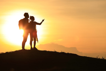 The silhouette of a lover, holding hands on the hills,