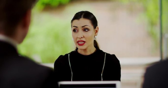 4K Emotional businesswoman trying to defend herself in disciplinary meeting with boss. Slow motion.
