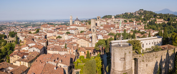 Naklejka premium Bergamo, Italy. Amazing drone aerial view of the old town. Landscape at the city center, its historical buildings and the towers