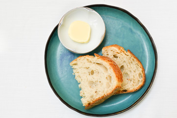 Bread and butter on blue plate - top view