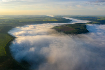 Canyon river in fog shooting from the air