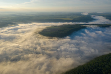 Fototapeta premium Canyon river in fog shooting from the air