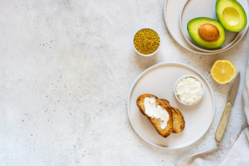Ingredients for cooking Toast with avocado, ricotta (cream cheese), bee pollen.