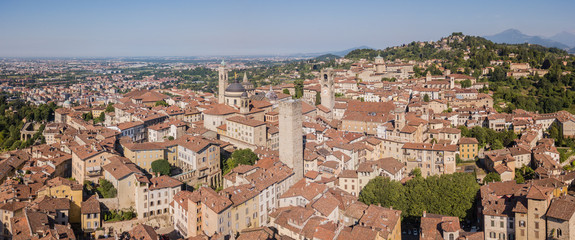 Naklejka premium Bergamo, Italy. Amazing drone aerial view of the old town. Landscape at the city center, its historical buildings and the towers