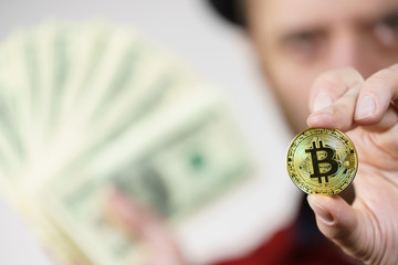 Man having bitcoin coin and cash