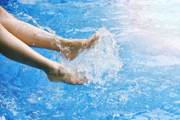 Enjoy beautiful girl relaxing in swimming pool, Happy girl splashing water in summer.