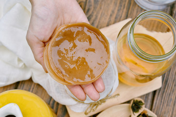 Kombucha, Hand holding scoby tea mushroom and ingredient, Healthy fermented food, Probiotic nutrition drink for good balance digestive system.