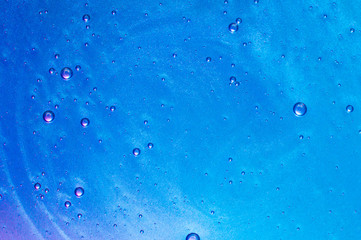 Abstract textured neon blue background transparent slime with bubbles