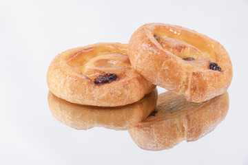 Two delicious puff pastry rolls with honey on top