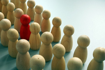Uniqueness concept. One unique figurine in the crowd.
