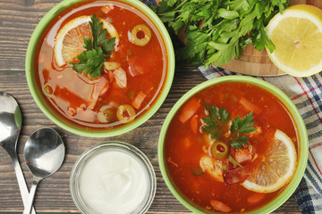 Two bowls with traditional Russian soup solyanka