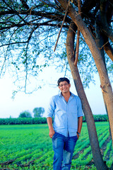 Young indian farmer at field