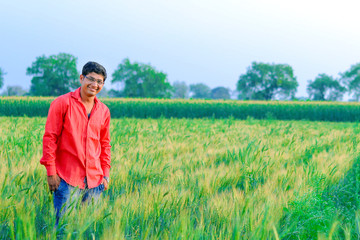 Naklejka na ściany i meble Young indian farmer at field