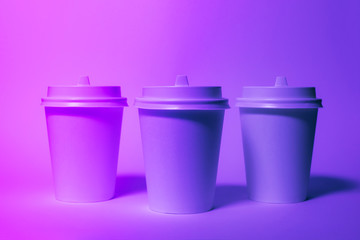 Paper disposable cups in trendy neon light.