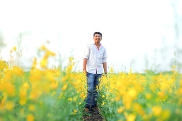 Young indian farmer at field