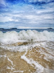 Closeup with the sandy beach splashing water and swash wave in Kota Kinabalu, Tanjung Aru beach....