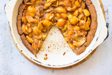 Tasty homemade apricot, apples, medlar baked tart, pie or cake with berries on light background surface. Top above view