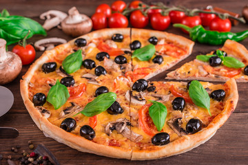 Tasty fresh hot pizza against a dark background. Pizza, food, vegetable, mushrooms