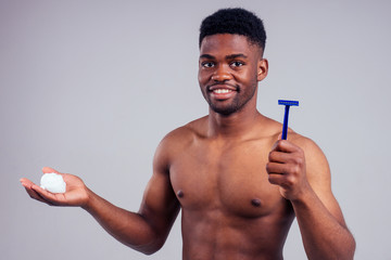 african american male shaving beard studio white background.