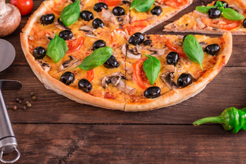 Tasty fresh hot pizza against a dark background. Pizza, food, vegetable, mushrooms