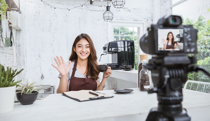 Startup successful small business owner sme beauty girl video online marketing with camera in cafe. Portrait of young asian tan woman barista cafe owner. SME entrepreneur business concept