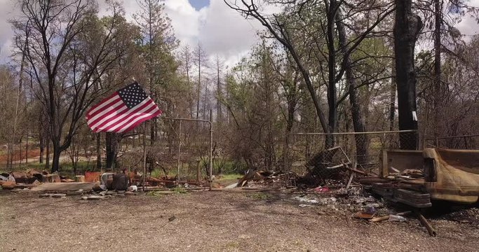 AERIAL ORBIT: American flag sways in breeze at ground zero for Paradise wildfire site. Signals sign of hope and new beginning for locals