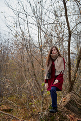 Girl in a red coat in the Park in late autumn