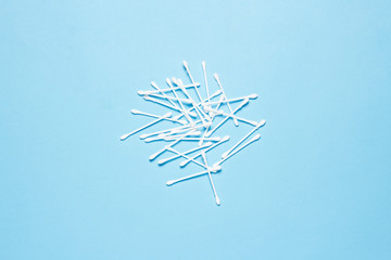 Cotton buds on a blue background. Concept of makeup, personal hygiene. Flat lay, top view