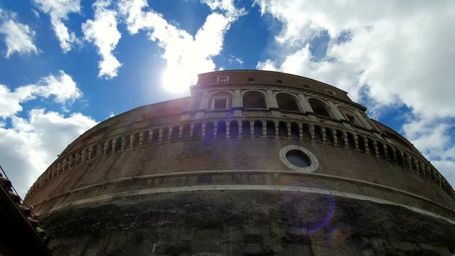 Castle Sant Angelo or Mausoleum, in Rome, Italy, against the blue sky.The sun's rays look from the castle. View from the foot of the castle uphill.