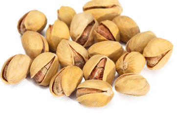 Fried salted pistachios on white background