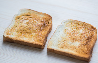 Crispy gold baked toast slices on a wooden table.