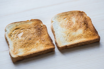 Crispy gold baked toast slices on a wooden table.