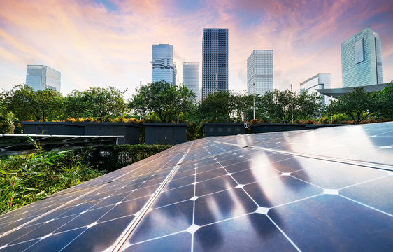 solar panel plant with urban modern building landscape landmarks in sunset,Ecological energy renewable concept