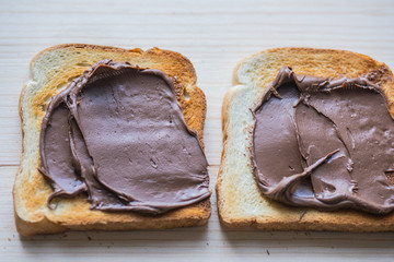 Beautiful dark brown chocolate nut cream..Placed on a toast sandwich slice.