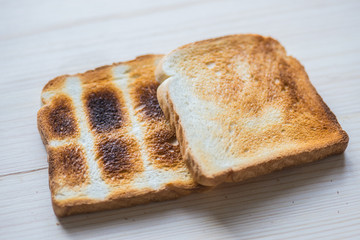 Crispy gold baked toast slices on a wooden table.