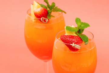 Colorful refreshing strawberry orange sunrise cocktail drinks in the glasses