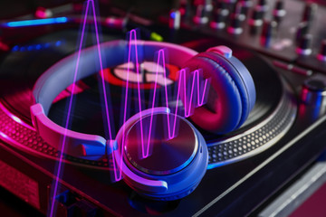 Headphones on modern DJ mixer, closeup