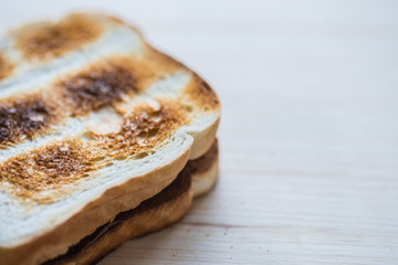 Crispy gold baked toast slices on a wooden table.