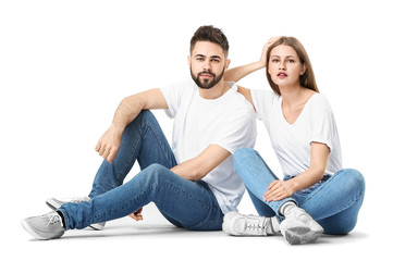 Fototapeta na wymiar Stylish young couple in jeans on white background