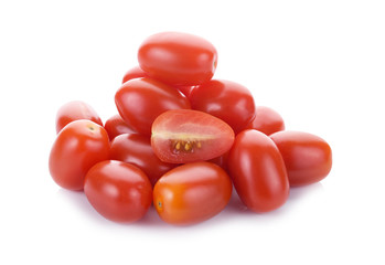 Falling plum tomatoes isolated on white background