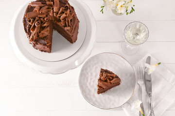Tasty chocolate cake on white table