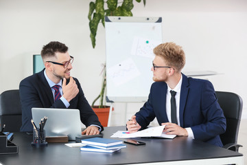 Business partners discussing project in office