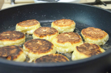 Cheesecakes, cottage cheese pancakes, cooking process. On the griddle.