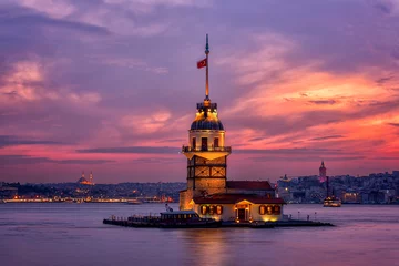 Fiery sunset over Bosphorus with famous Maiden's Tower (Kiz Kulesi) also known as Leander's Tower, symbol of Istanbul, Turkey. Scenic travel background for wallpaper or guide book © larauhryn