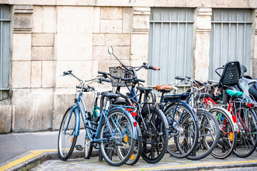 Fototapeta na wymiar Street parking of bicycles in Paris - the city where the bicycle is popular means of transportation